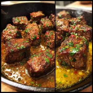 Close-up of delicious cowboy butter steak bites sizzling in a cast-iron skillet with herbs and chili flakes.